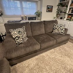 Brown Sofa-bed and Loveseat Couches With Patterned Pillows