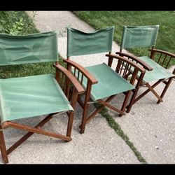 Three green studio directors chairs 