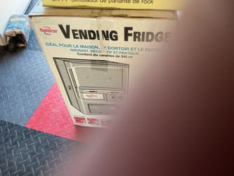 Refrigerator vending counter top holds 12 oz sodas  uses coin or tokens