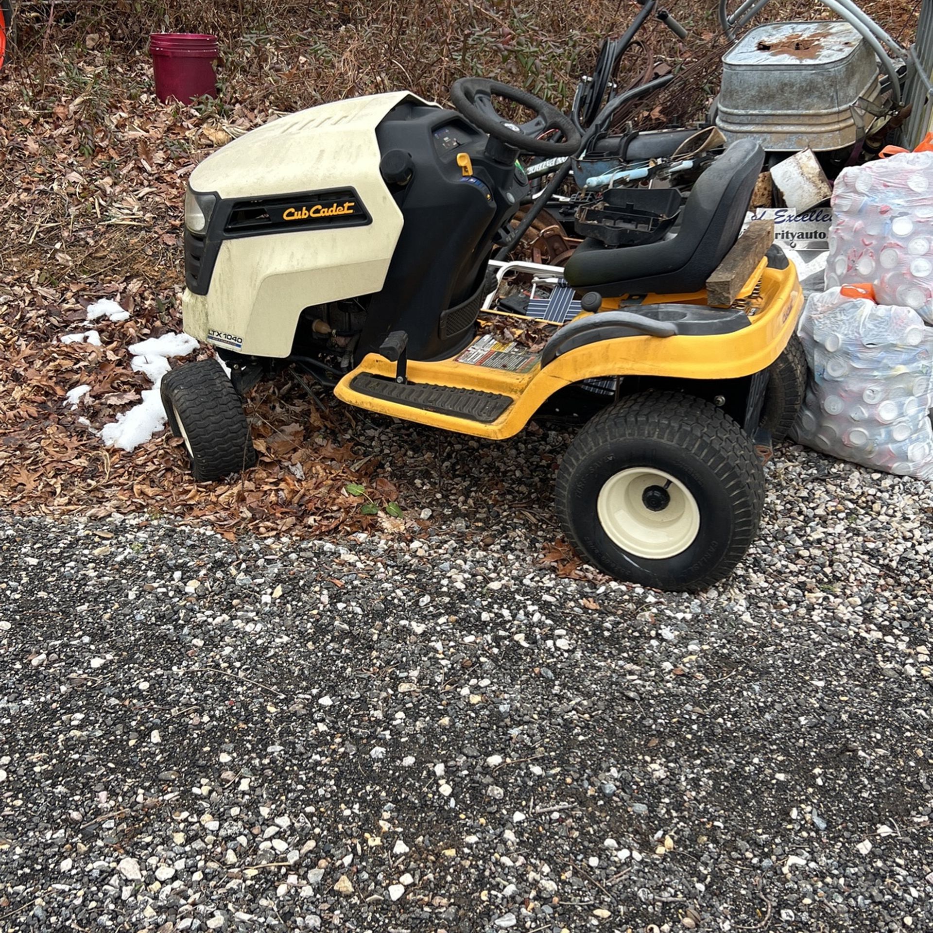 A cub cadet, yellow and black twin cam and has a mower with it