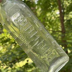 Very Old Glass Baby Bottle With Embossed mother cat, and two kittens playing with yarn