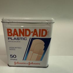 vintage tin of Band-Aid Plastic Bandages by Johnson & Johnson. The tin contains 50 sterile bandages of assorted sizes.