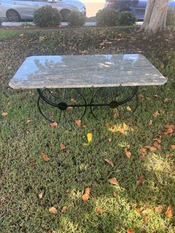 Wrought iron wagon table. Granite top