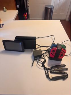 Nintendo Switch with dock, remotes, and remote charger