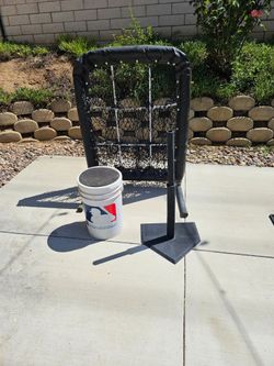 9 hole pitching net with bucket of balls and batting tee