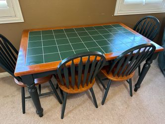 Green tile top table with four chairs