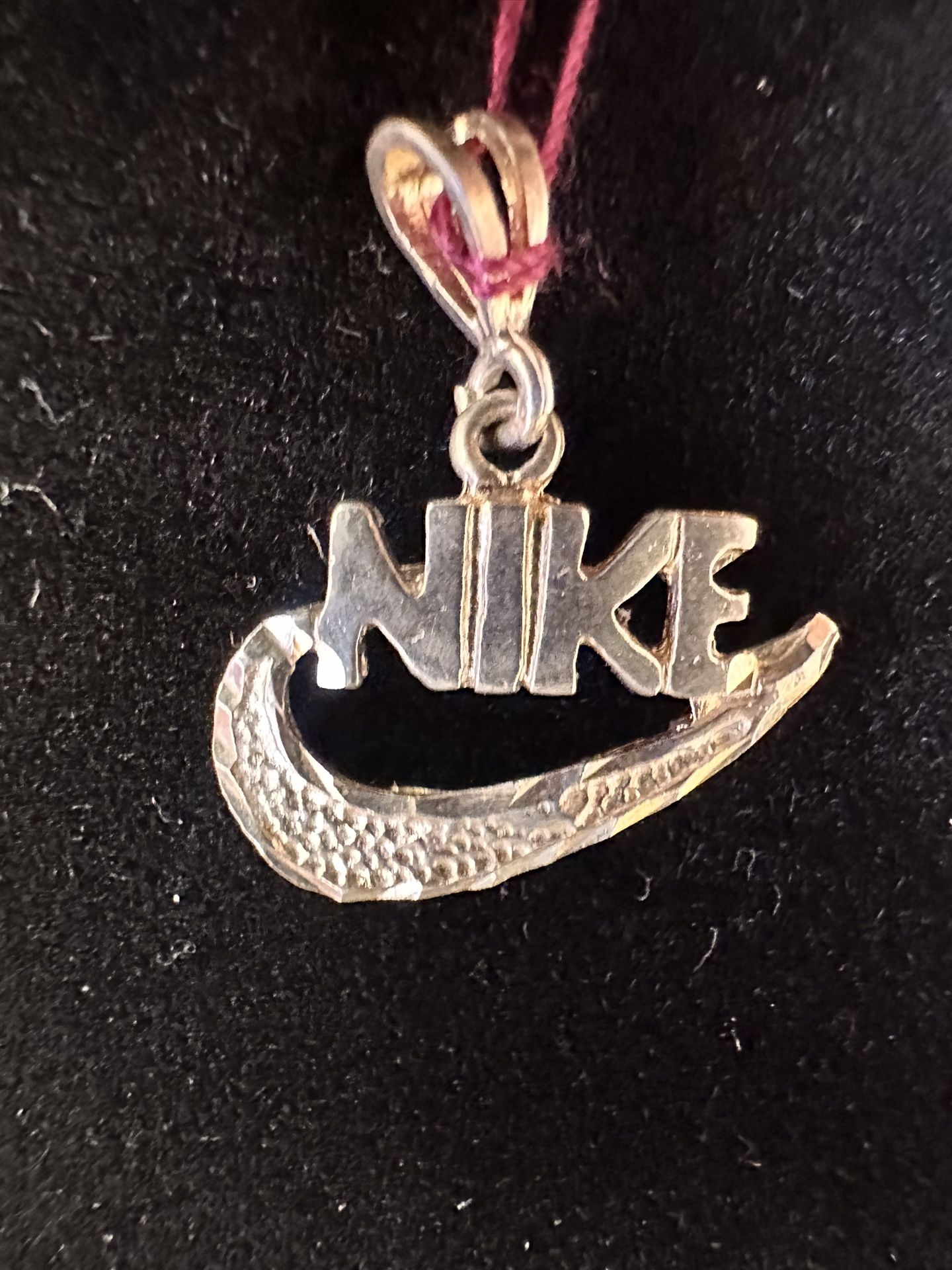 2 Silver Nike Branded Silver Pendants. $15/each