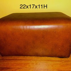 engineered Leather Ottoman In Really Good Condition. If You Want It Taller You Could Add Legs Right Now. It Just Has Metal Coasters.