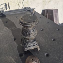 A vintage miniature cast iron pot-belly stove