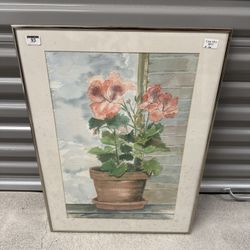 Signed Mary Drennen framed watercolor painting featuring pink geraniums in a terracotta pot, set against a window and what appears to be a rustic wood