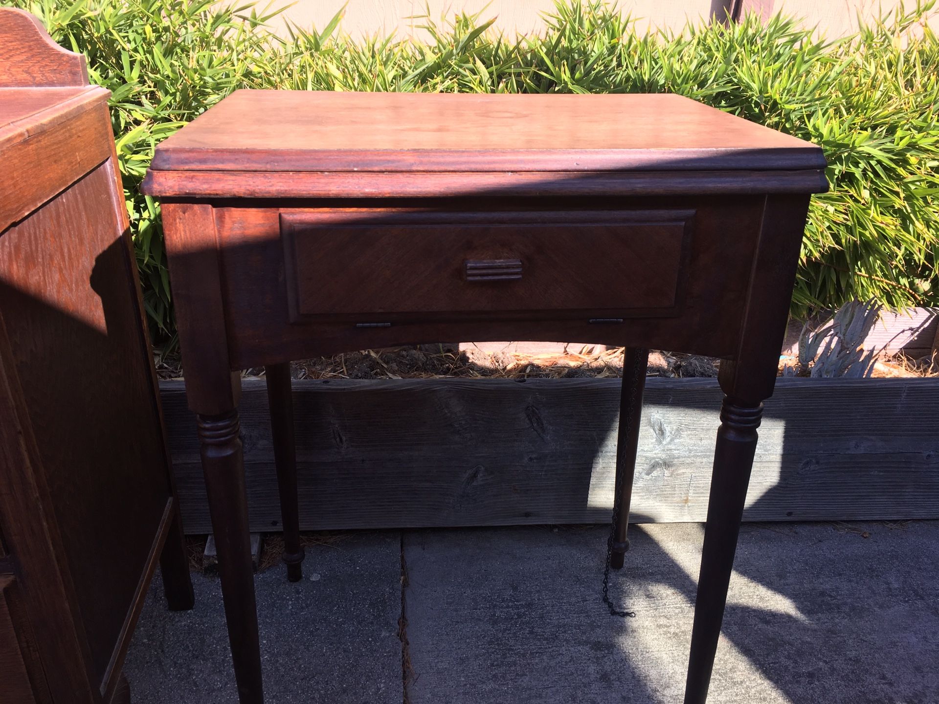Antique sewing machine cabinet with front door