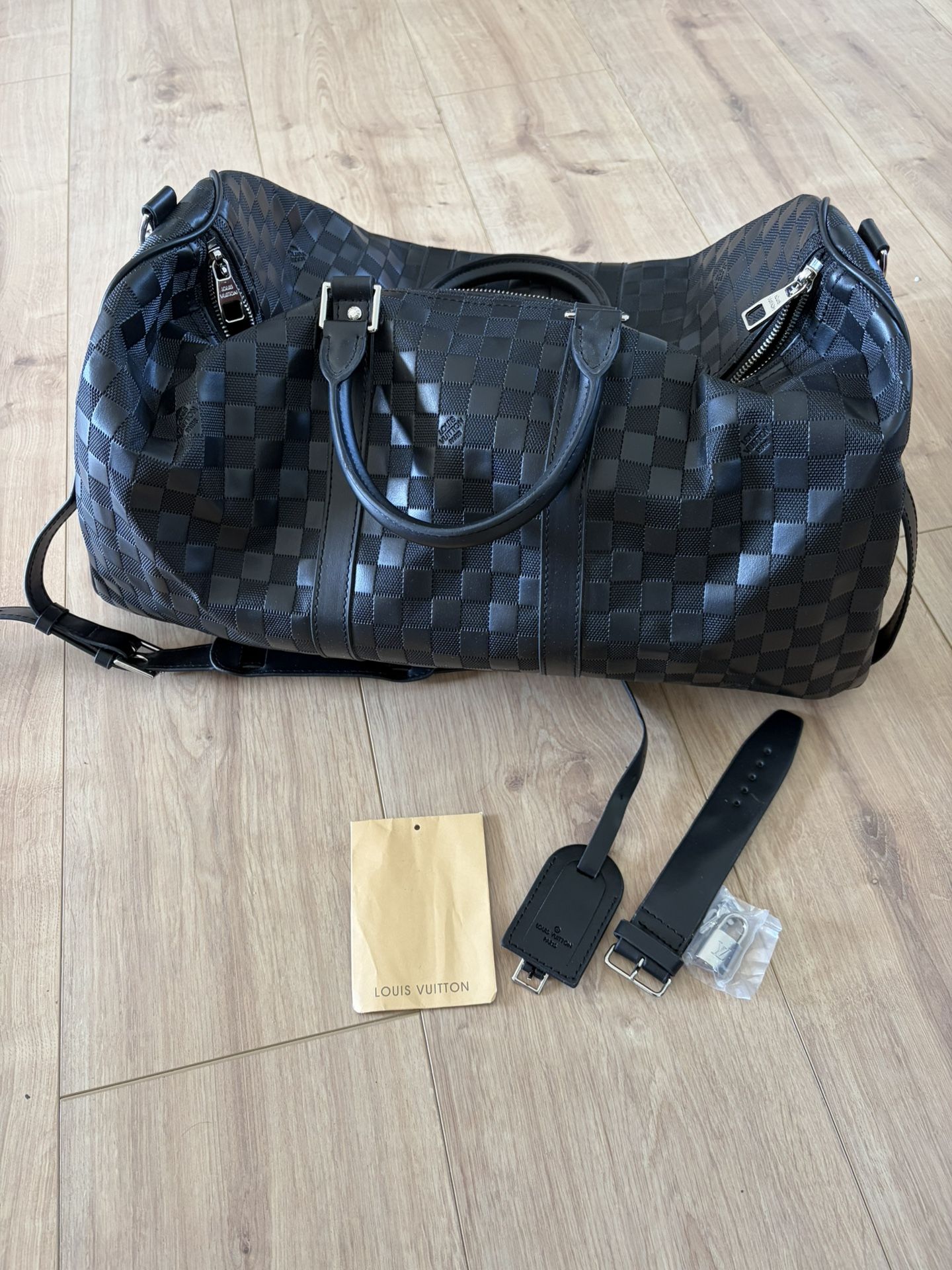 Black Louis Vuitton checkered duffle bag