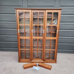 3 door Media storage cabinet Walnut color wood & glass 47"W X 61.5"T X 9.5"D with 18 adjustable shelves expandable to 24