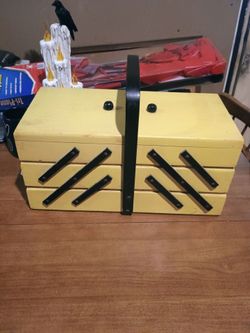 yellow Eames-era accordion sewing box full of sewing stuff