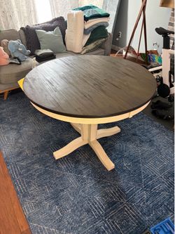 Expandable round wooden dining table with 4 chairs