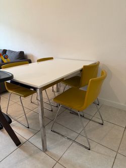White Dining Table with 4 Yellow Chairs