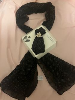 Scarf with a floral clip