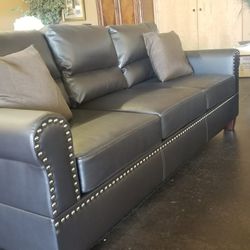 Dark brown faux leather sofa and loveseat