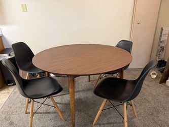 Brown round dining table with 4 included black chairs + expandable parts