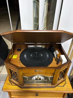 Emerson Heritage Vintage-Style Audio System resting on a matching wooden stand with record storage slots
