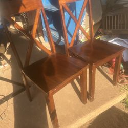 a pair of nice wood chairs seats are 18 inches tall