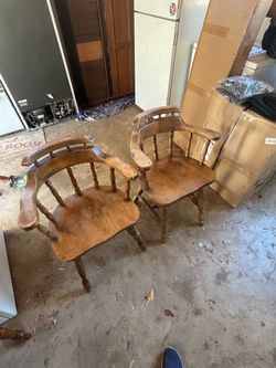Two wooden captains chairs
