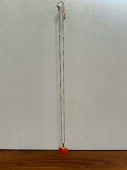 Gold necklace with orange heart pendant