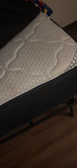 Twin size mattress with black metal frame