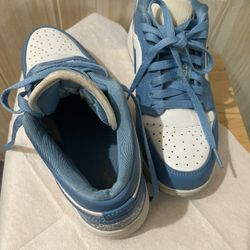 This is an authentic pair of Air Jordan 1 Low "UNC" sneakers. Barely use ladies size 6 ladies