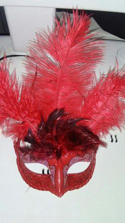 Red masquerade mask with feathers
