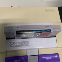 Super Nintendo Entertainment System (SNES) console with a Super Mario All-Stars game