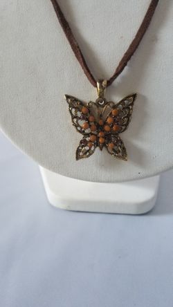 A Brown and beige stone butterfly necklace on 20" leather cord adjustable
