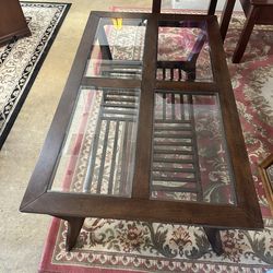 Dark brown wood coffee table with glass top