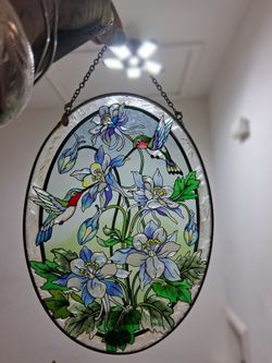 hand-painted Amia Studios suncatcher features hummingbirds flowers