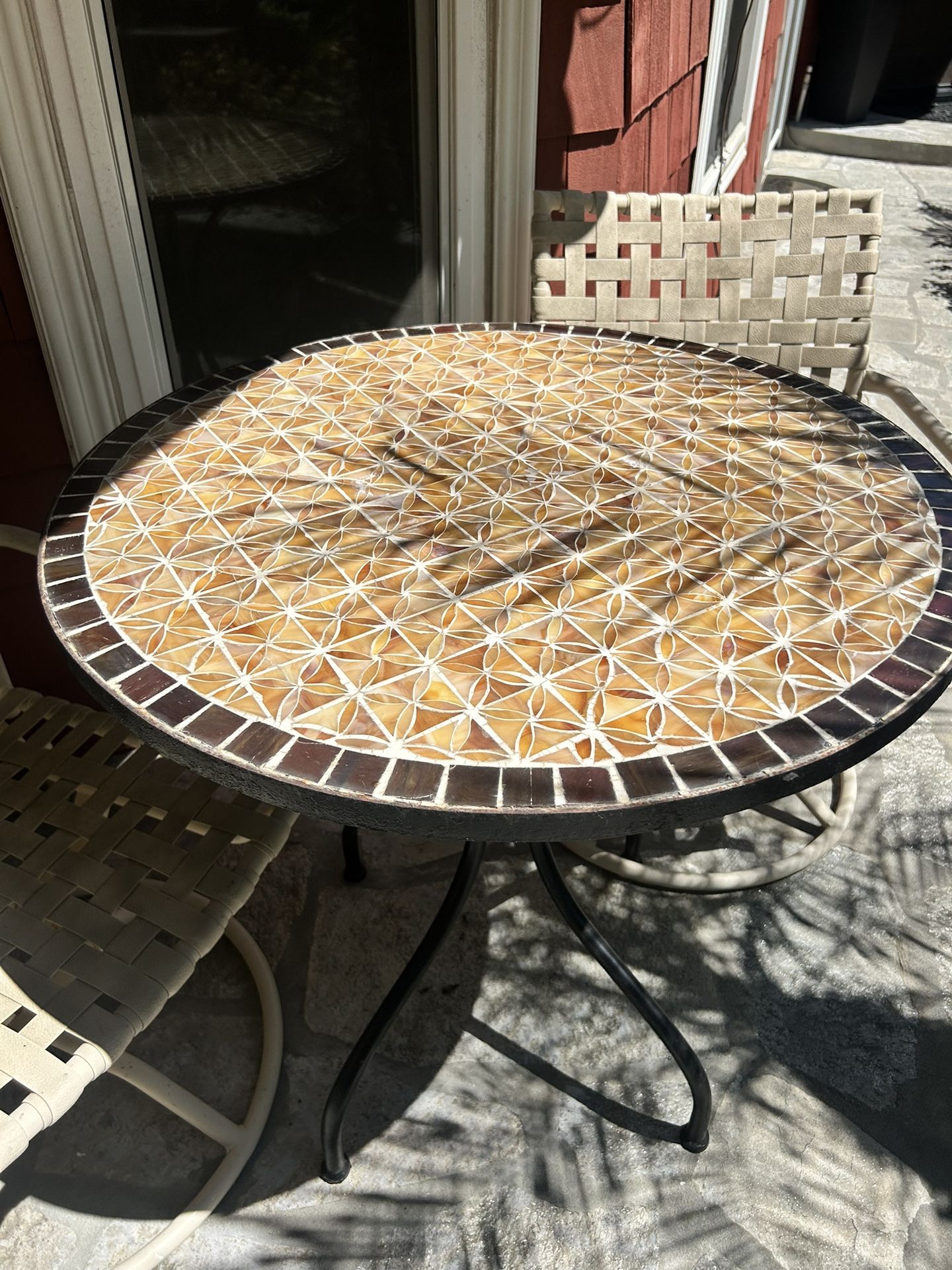 3 Piece Outdoor Bistro Set with Tiled Table Table is hand made tile and heavy. Chairs are swiveling