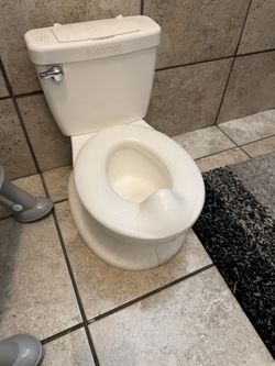 toddler potty training toilet. Makes a flushing sound and has a small storage compartment.