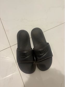 Size 10, black Nike slides