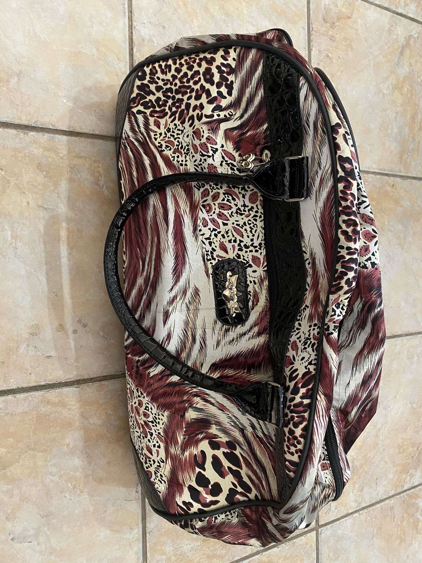 Kathy Van Zeeland Rolling Duffel Bag.