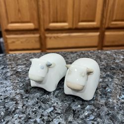 Vintage Porcelain Cow Pair of Salt And Pepper Shakers.  Size approximately 1 3/4 inches tall.  Has been on display in a cabinet with a very large salt