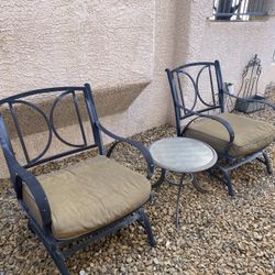 Two chairs  outside doors with coffee table 