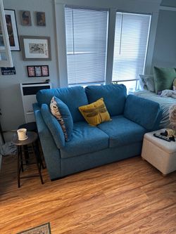 Blue two seater sofa