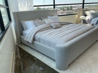 New King size gray fabric upholstered platform bed.