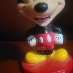vintage Walt Disney World Resort Mickey Mouse Bobble Head. 
This collectible features Mickey Mouse in his classic attire, standing on a base with the 