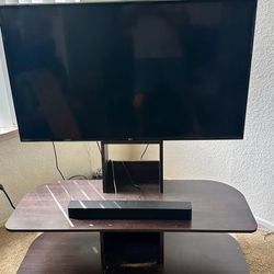 MUST GO !!!! LG 49 inch smart tv with vizio sound bar and tv table all for one price.