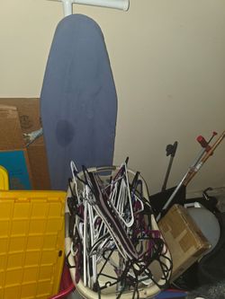 Laundry basket of hangers and iron board