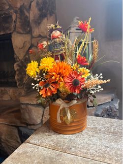 Ht-13.5in width-13in HANDMADE Artificial Fall arrangement in a rust color ceramic vase with scarecrow