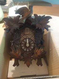 Carved wooden quartz cuckoo clock
