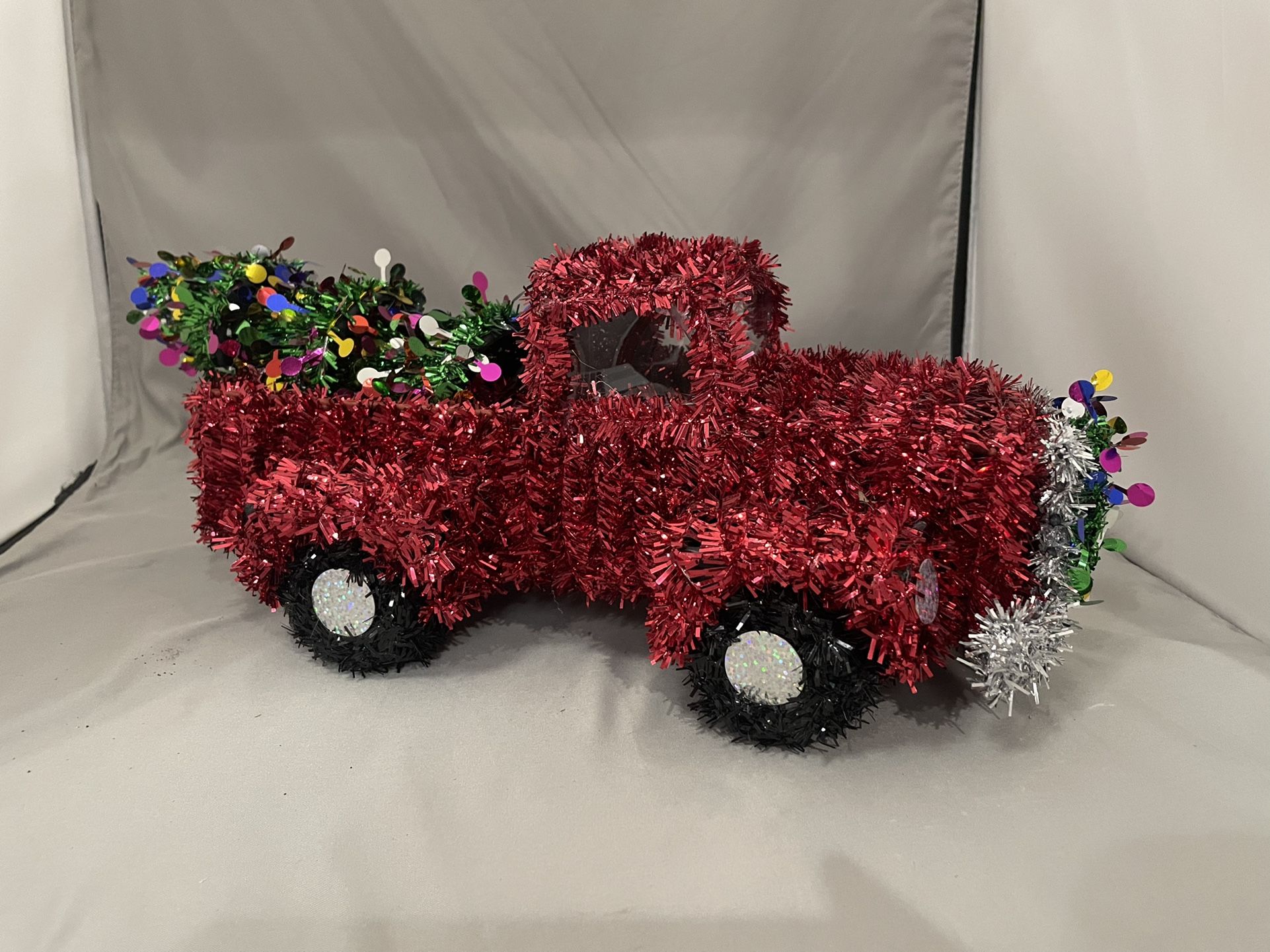 Red Tinsel Decorated Truck With Christmas Tree and Wreath Decoration 