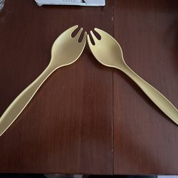 These are vintage Tupperware salad serving forks, also known as tongs or sporks, in the 1970s "Harvest Gold" color.