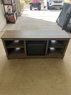 Entertainment center with fireplace.